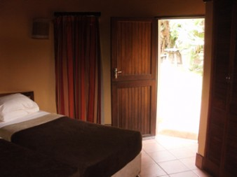 Comfortable bedroom interior inside a two-bed rondavel at Hilltop Camp